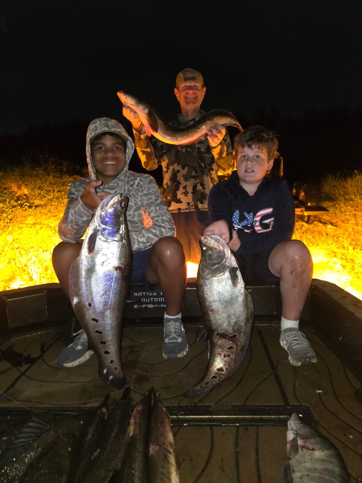 Native Roots Outdoor bowfishing trip photo with guests, fish, boat lights, and South Florida water