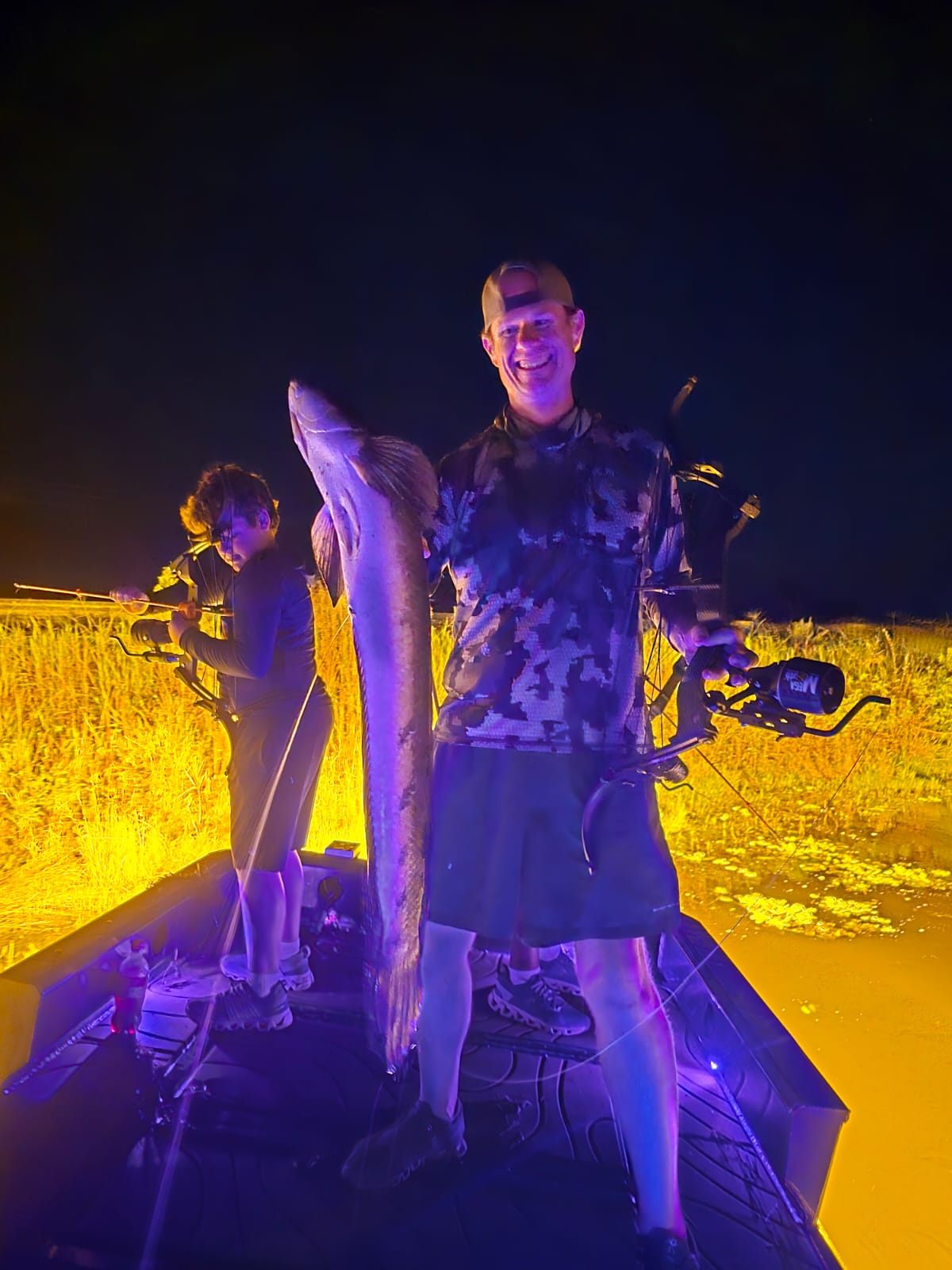 Native Roots Outdoor bowfishing trip photo with guests, fish, boat lights, and South Florida water