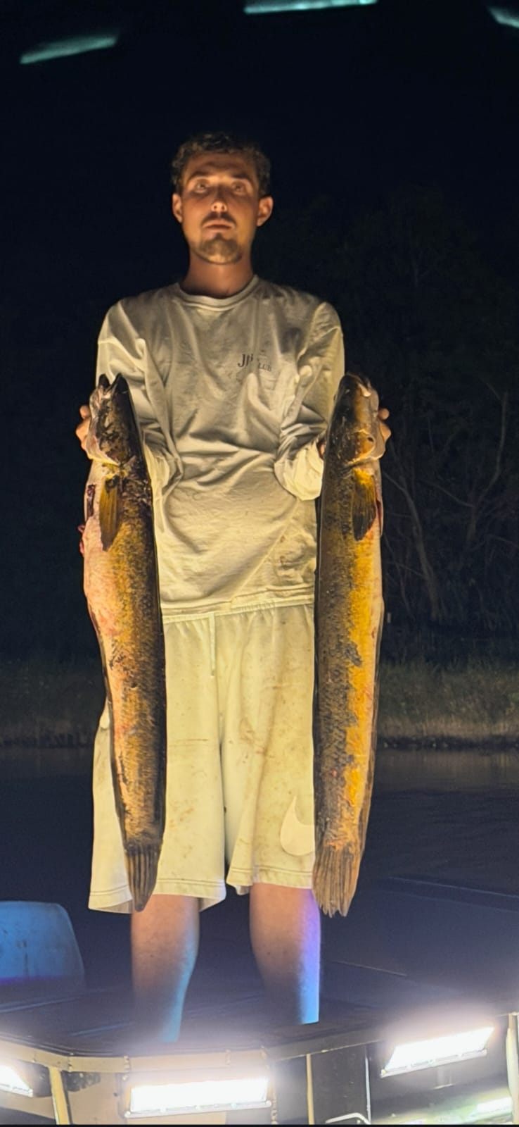 Native Roots Outdoor bowfishing trip photo with guests, fish, boat lights, and South Florida water