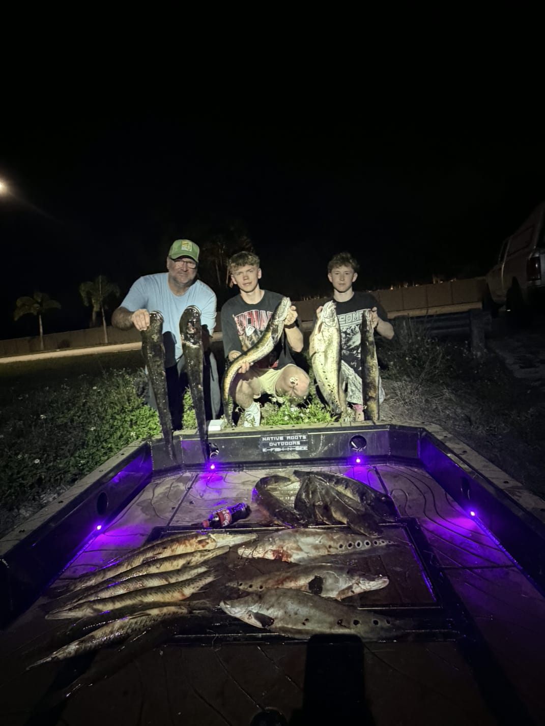 Native Roots Outdoor bowfishing trip photo with guests, fish, boat lights, and South Florida water