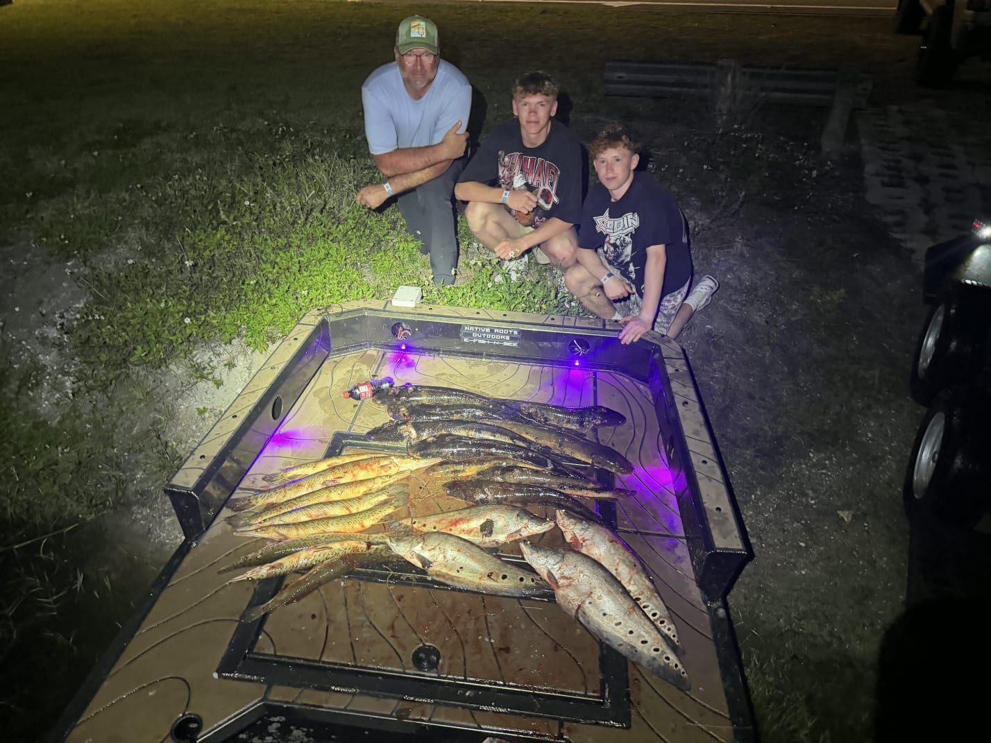 Native Roots Outdoor bowfishing trip photo with guests, fish, boat lights, and South Florida water