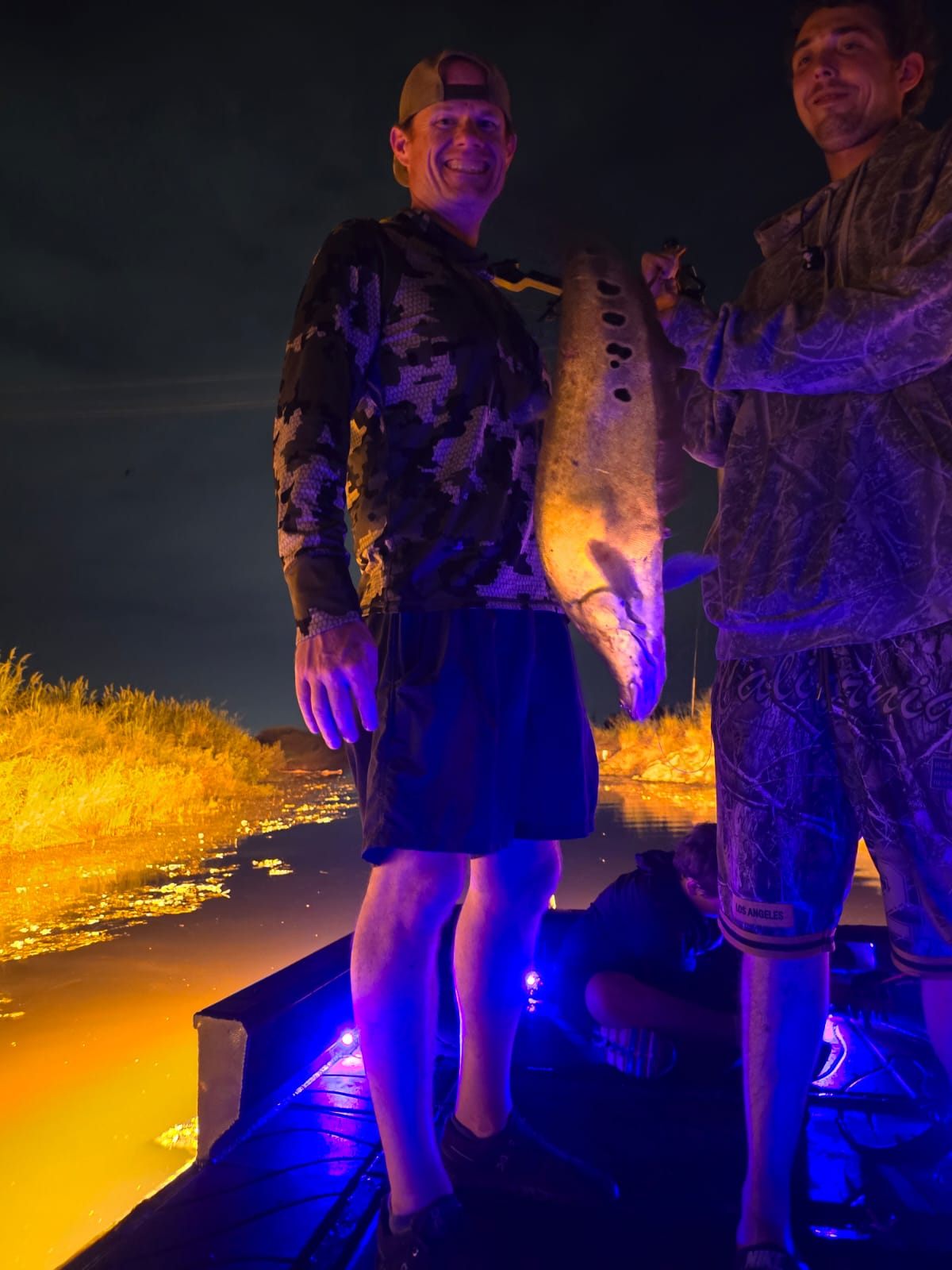 Native Roots Outdoor bowfishing trip photo with guests, fish, boat lights, and South Florida water