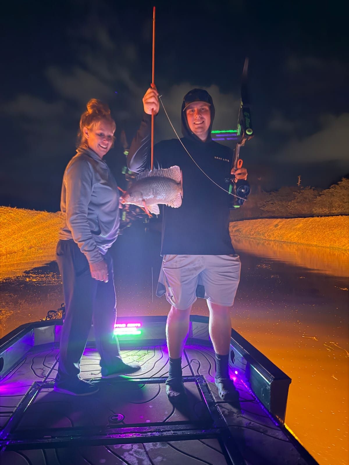 Native Roots Outdoor bowfishing trip photo with guests, fish, boat lights, and South Florida water