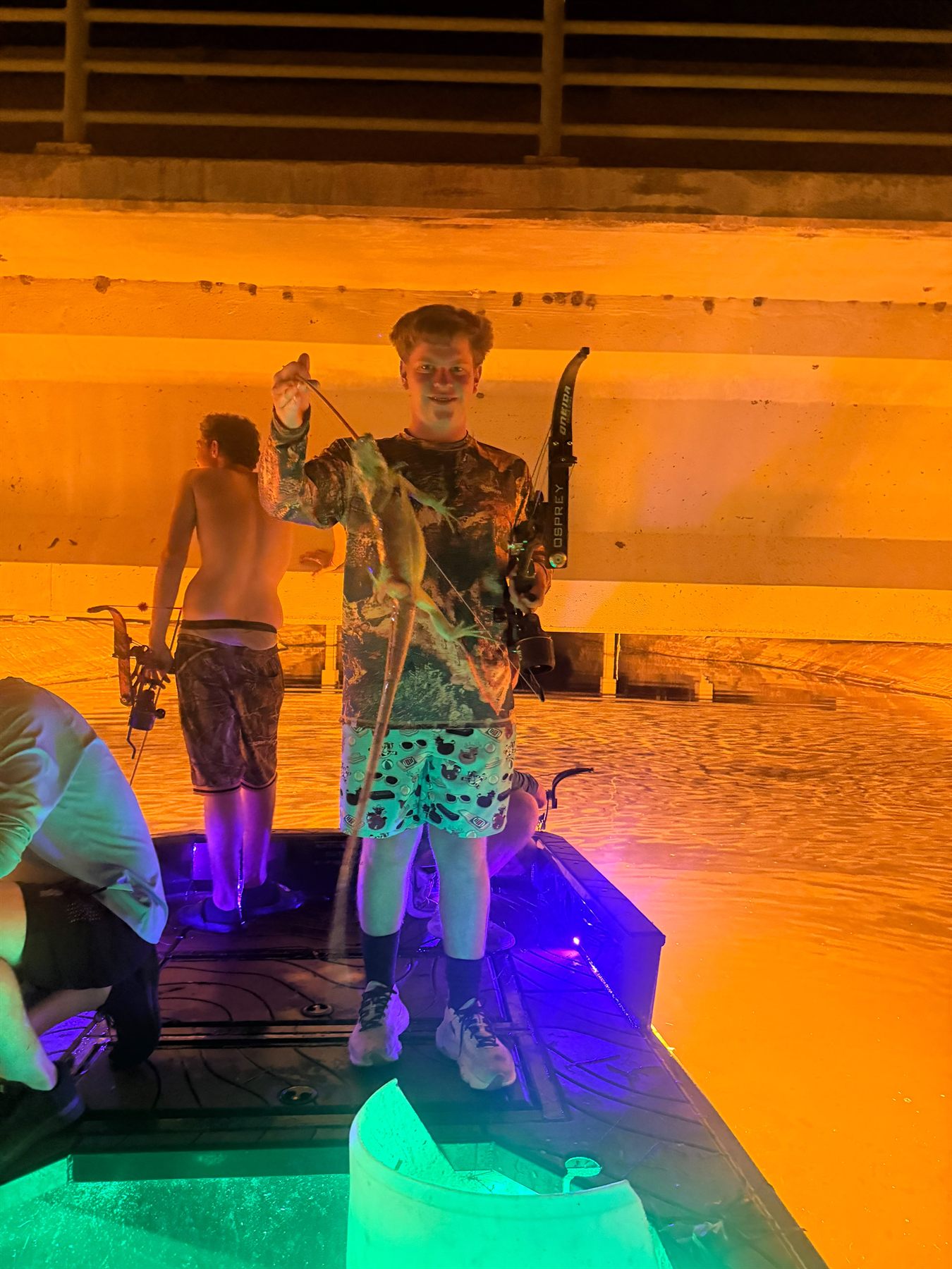 Native Roots Outdoor bowfishing trip photo with guests, fish, boat lights, and South Florida water