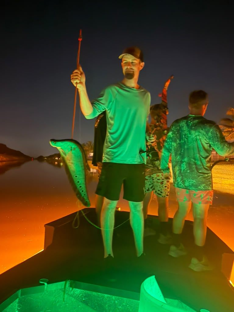 Native Roots Outdoor bowfishing trip photo with guests, fish, boat lights, and South Florida water