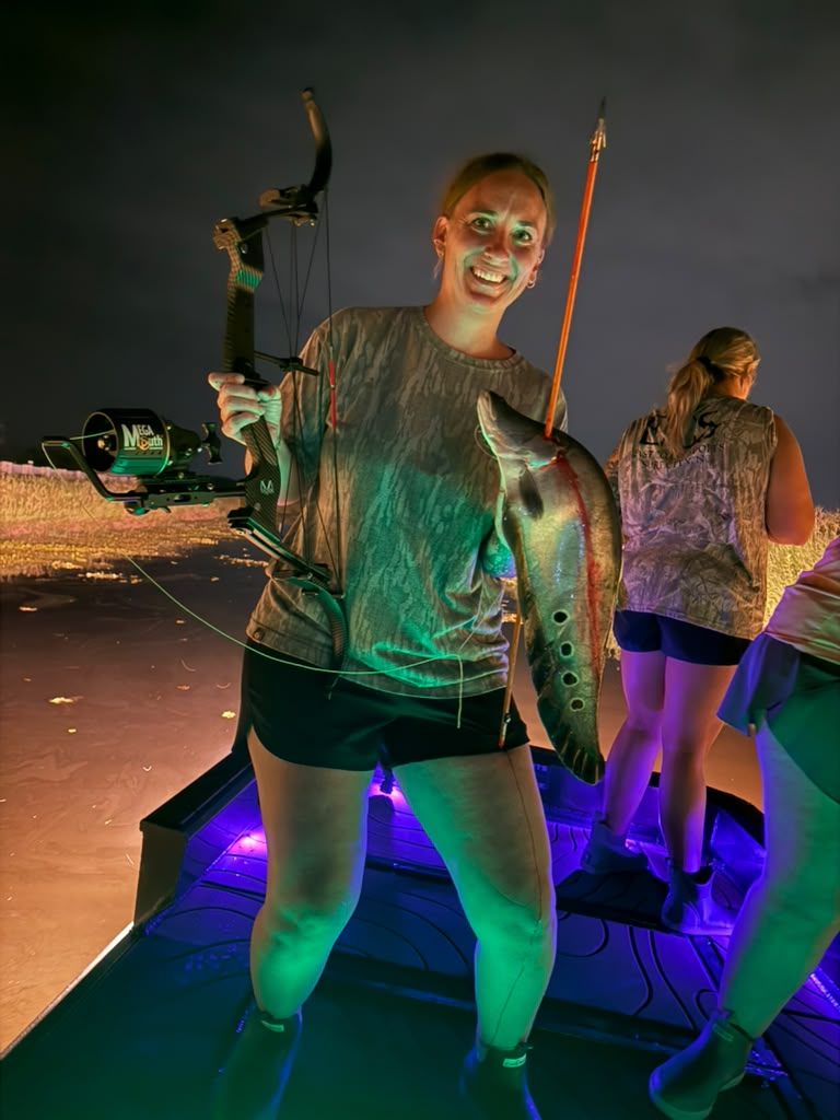 Native Roots Outdoor bowfishing trip photo with guests, fish, boat lights, and South Florida water