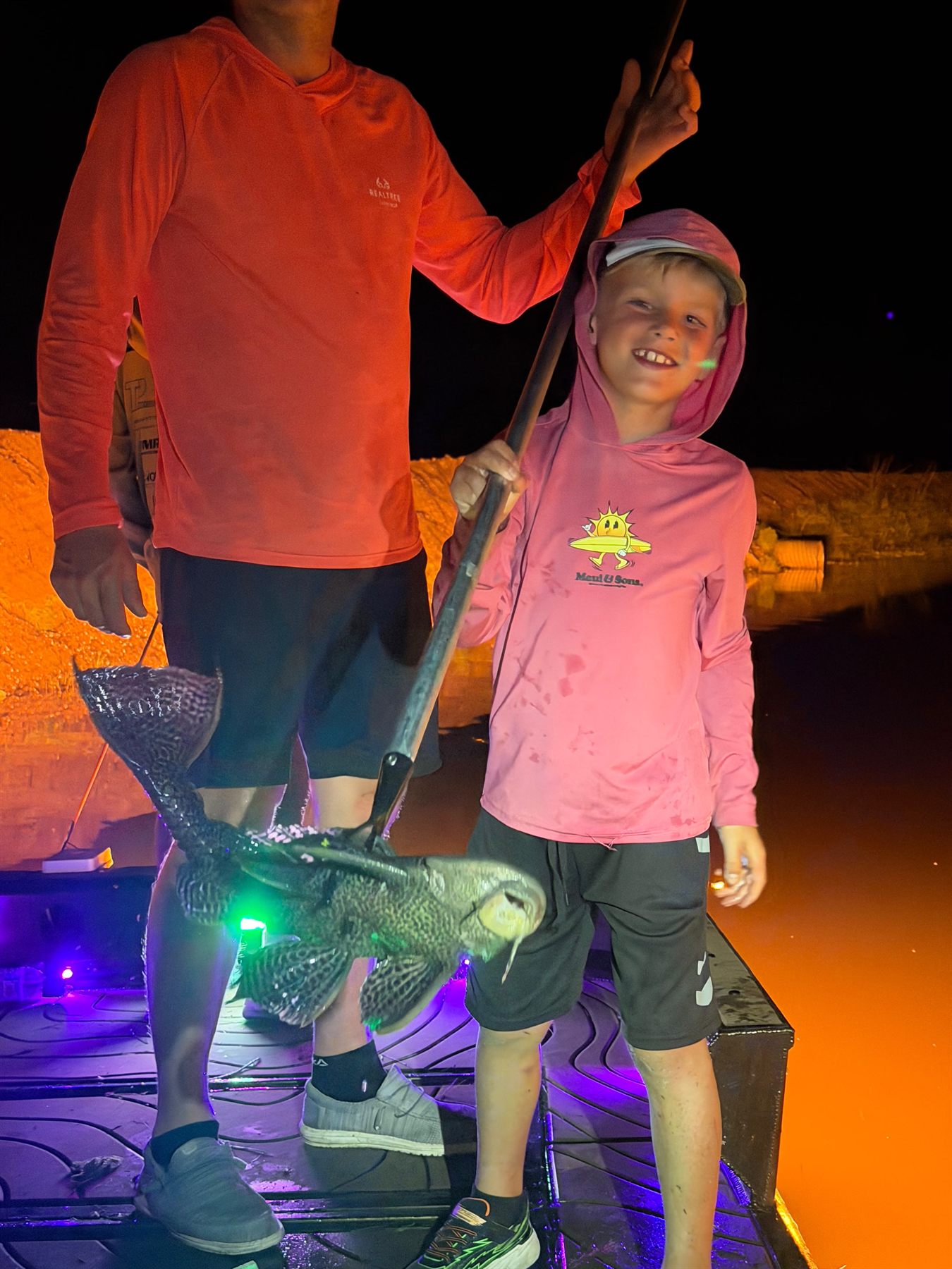 Native Roots Outdoor bowfishing trip photo with guests, fish, boat lights, and South Florida water