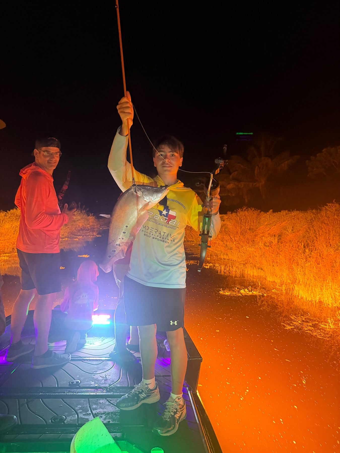 Native Roots Outdoor bowfishing trip photo with guests, fish, boat lights, and South Florida water