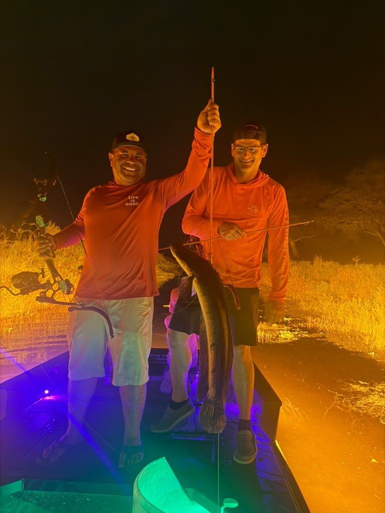 Native Roots Outdoor bowfishing trip photo with guests, fish, boat lights, and South Florida water
