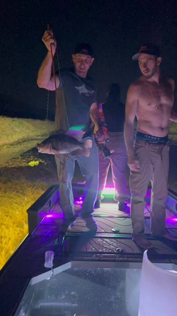 Native Roots Outdoor bowfishing trip photo with guests, fish, boat lights, and South Florida water