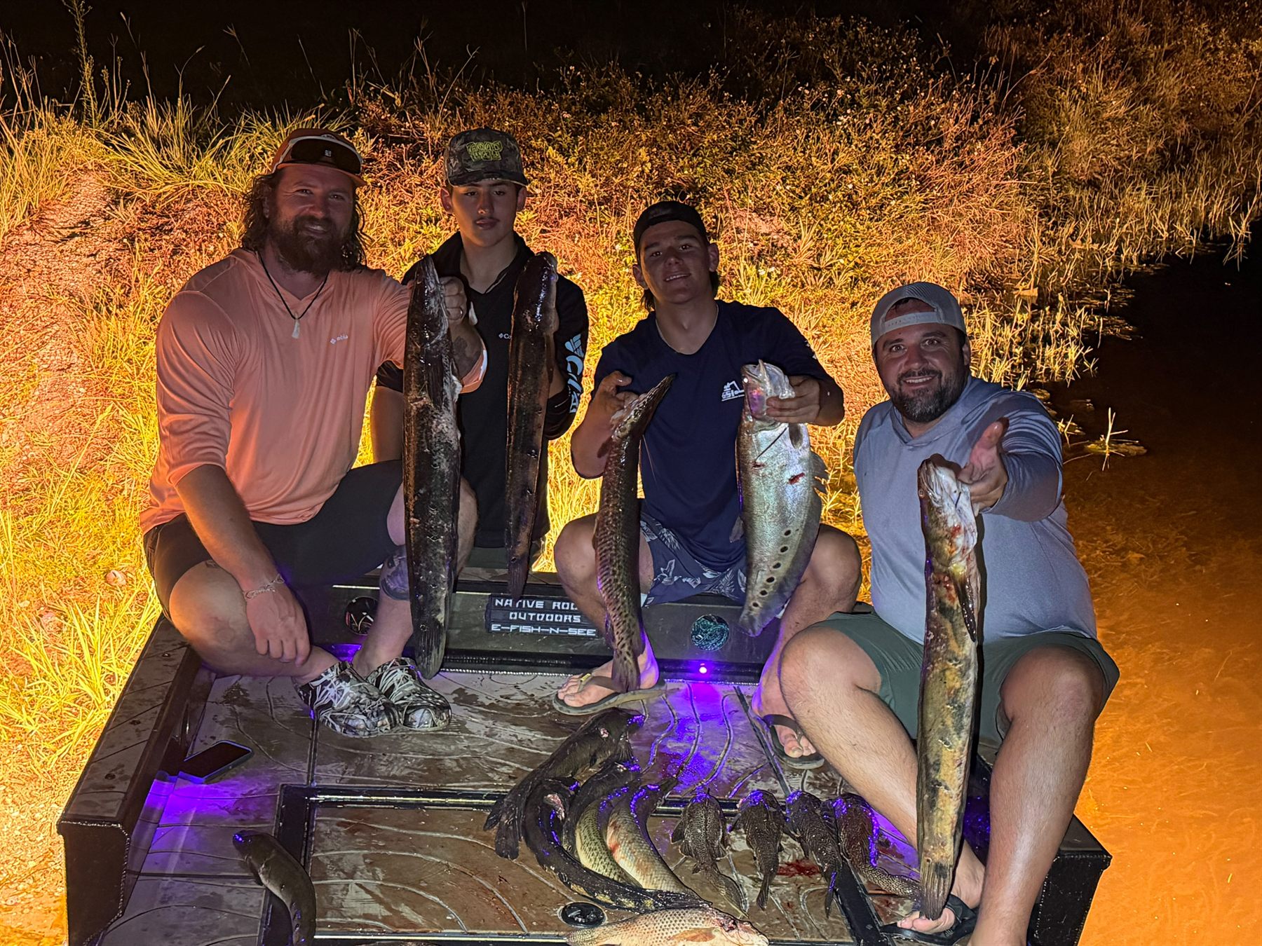 Native Roots Outdoor bowfishing trip photo with guests, fish, boat lights, and South Florida water