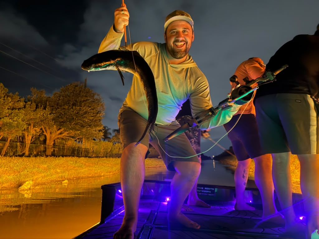 Native Roots Outdoor bowfishing trip photo with guests, fish, boat lights, and South Florida water