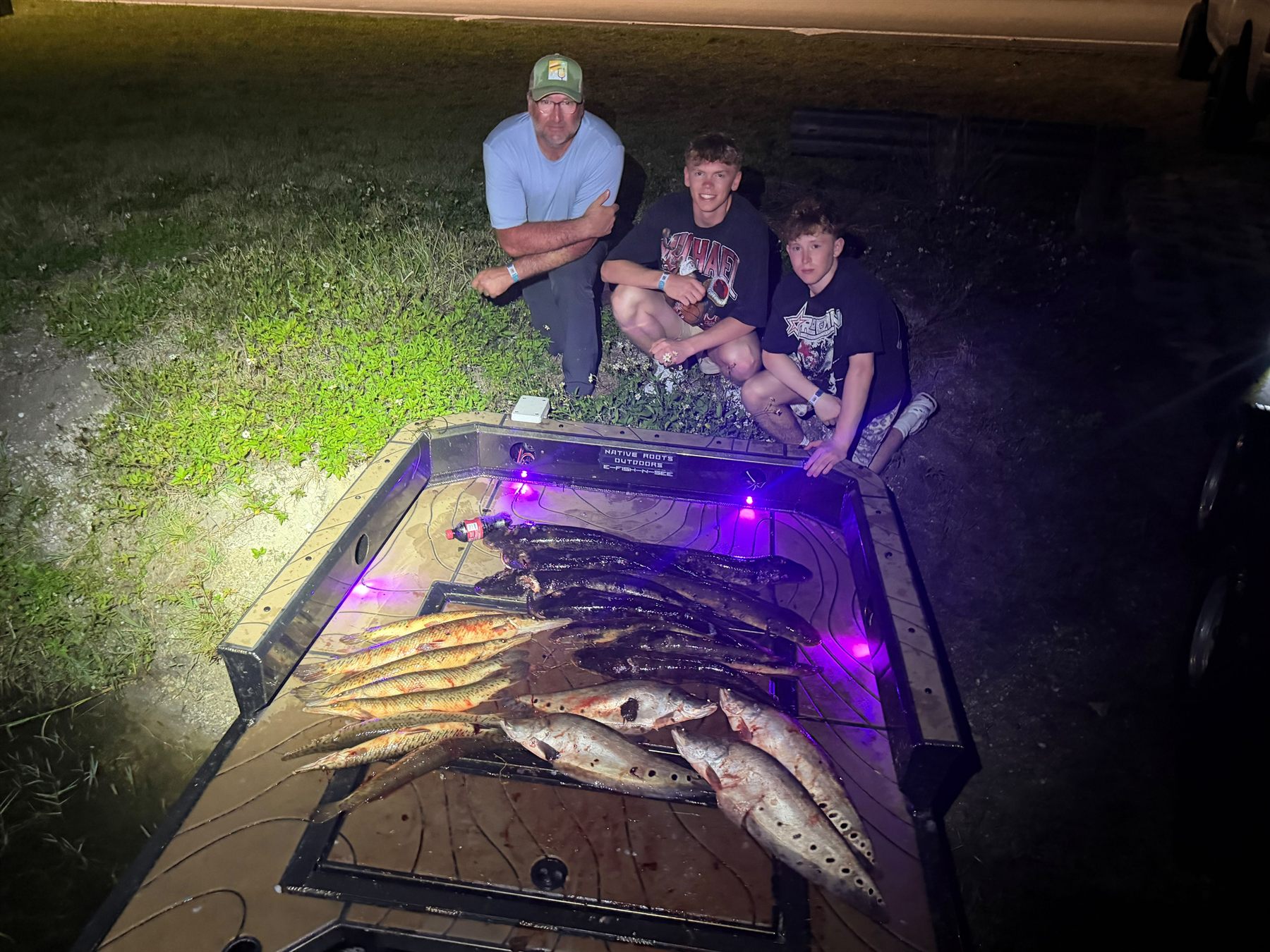 Native Roots Outdoor bowfishing trip photo with guests, fish, boat lights, and South Florida water