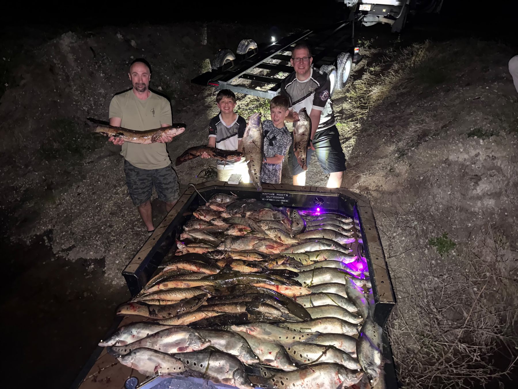 Native Roots Outdoor bowfishing trip photo with guests, fish, boat lights, and South Florida water