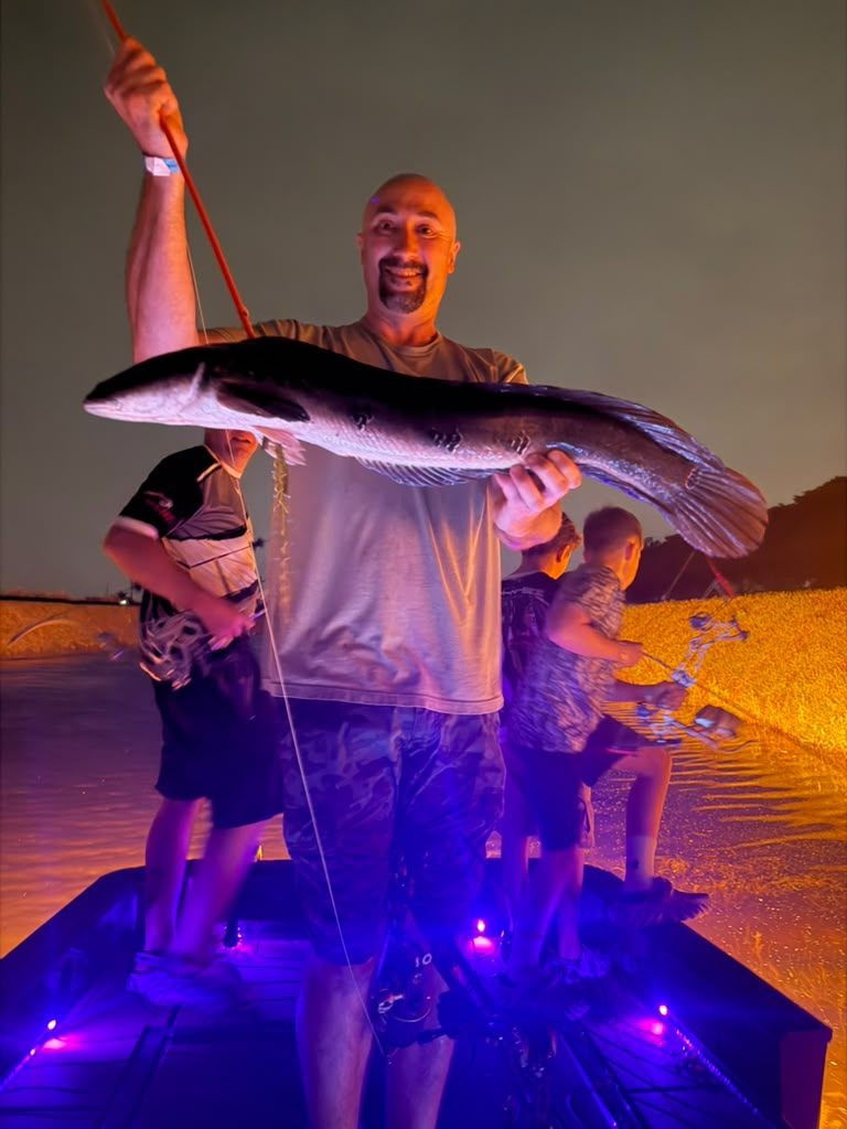 Native Roots Outdoor bowfishing trip photo with guests, fish, boat lights, and South Florida water