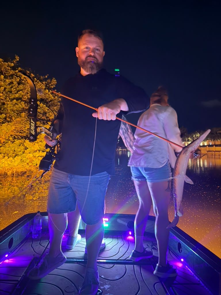 Native Roots Outdoor bowfishing trip photo with guests, fish, boat lights, and South Florida water