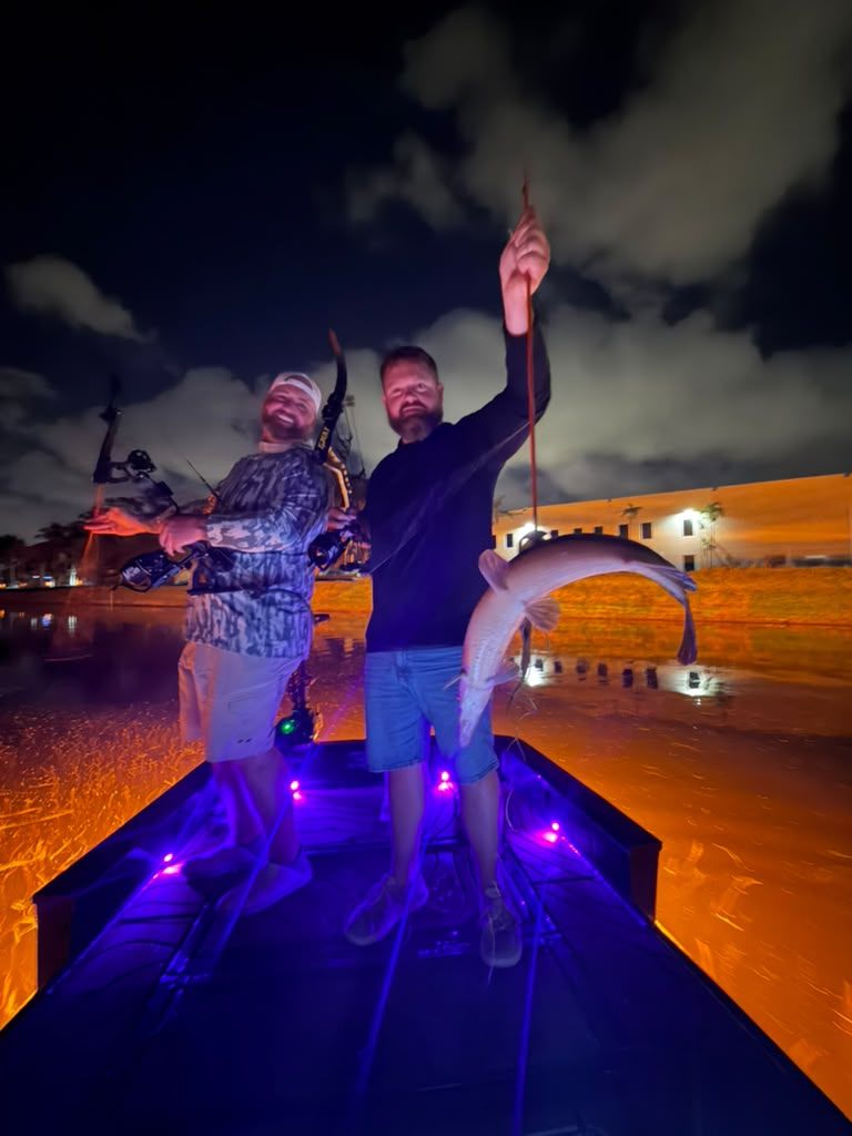 Native Roots Outdoor bowfishing trip photo with guests, fish, boat lights, and South Florida water