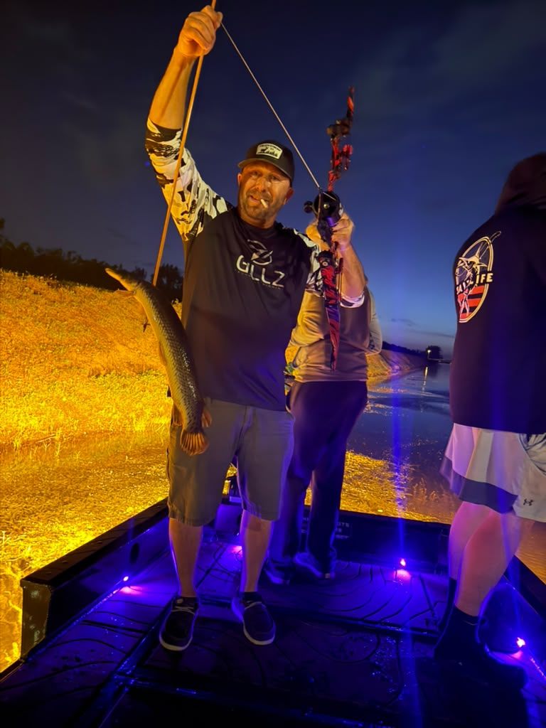 Native Roots Outdoor bowfishing trip photo with guests, fish, boat lights, and South Florida water