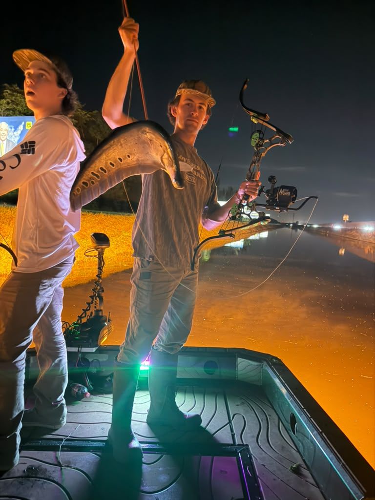 Native Roots Outdoor bowfishing trip photo with guests, fish, boat lights, and South Florida water