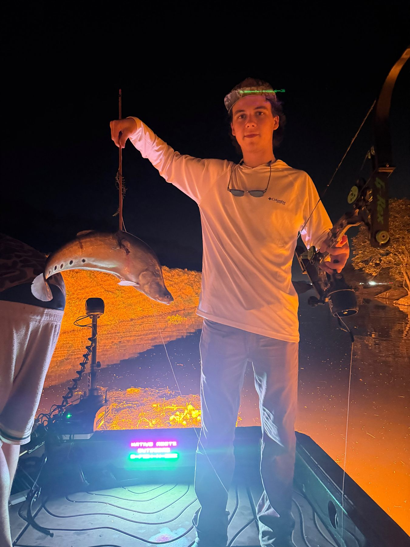 Native Roots Outdoor bowfishing trip photo with guests, fish, boat lights, and South Florida water