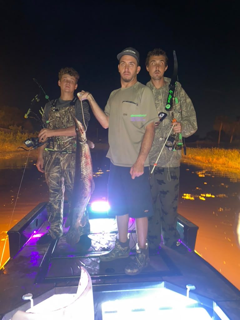 Native Roots Outdoor bowfishing trip photo with guests, fish, boat lights, and South Florida water
