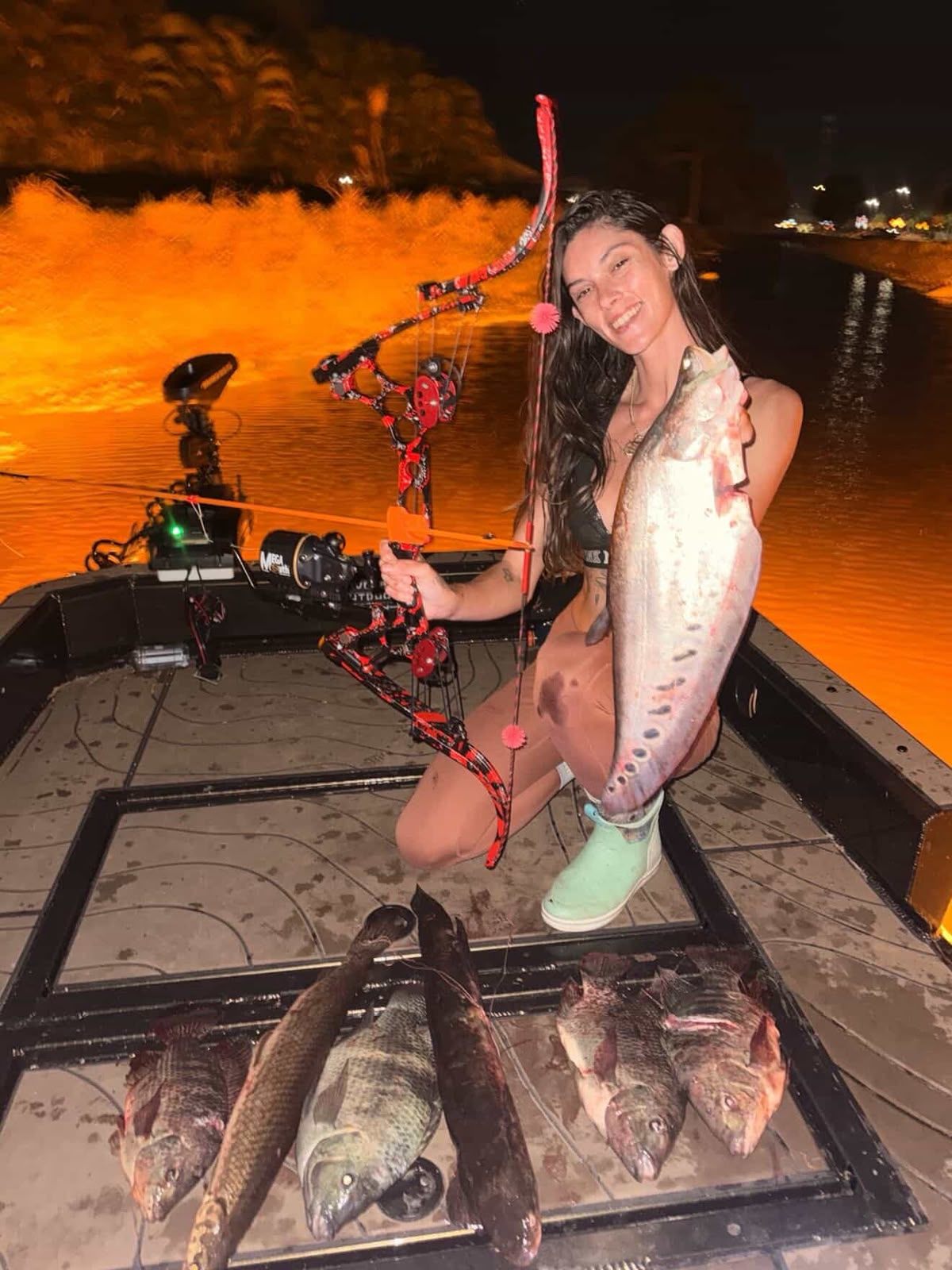 Native Roots Outdoor bowfishing trip photo with guests, fish, boat lights, and South Florida water