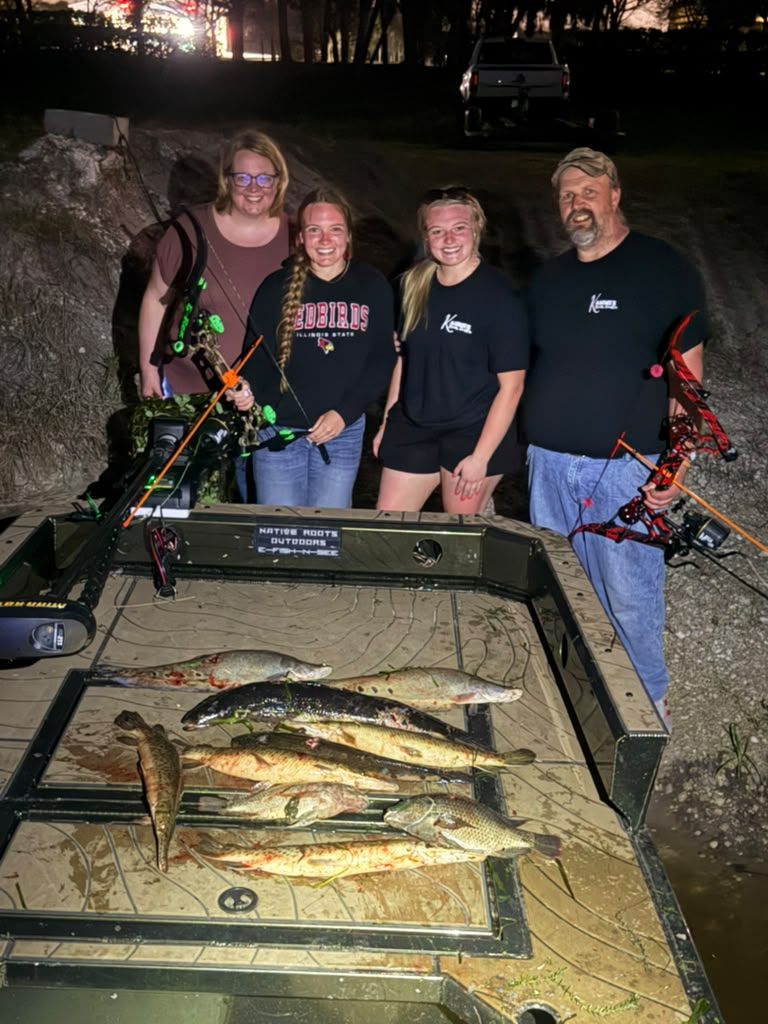 Native Roots Outdoor bowfishing trip photo with guests, fish, boat lights, and South Florida water