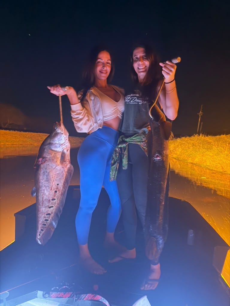 Native Roots Outdoor bowfishing trip photo with guests, fish, boat lights, and South Florida water