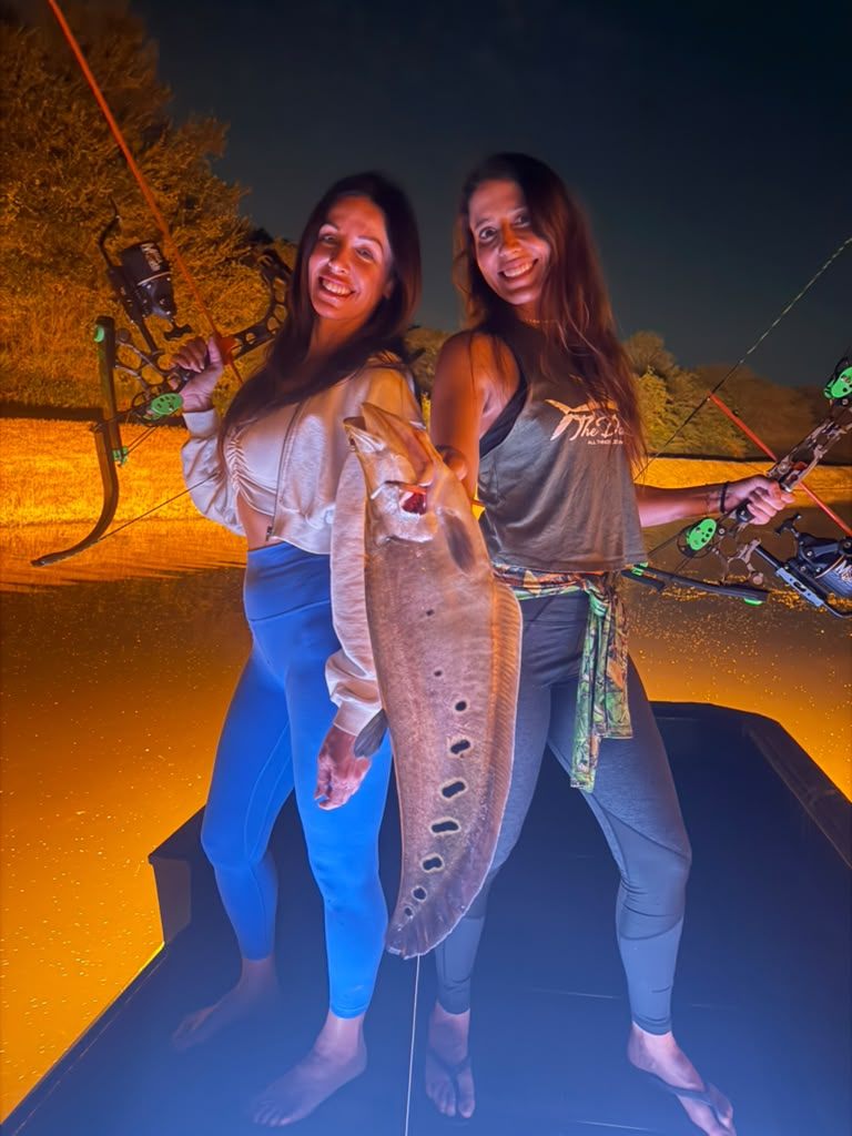 Native Roots Outdoor bowfishing trip photo with guests, fish, boat lights, and South Florida water