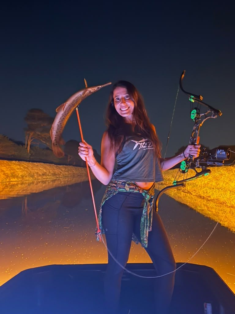 Native Roots Outdoor bowfishing trip photo with guests, fish, boat lights, and South Florida water