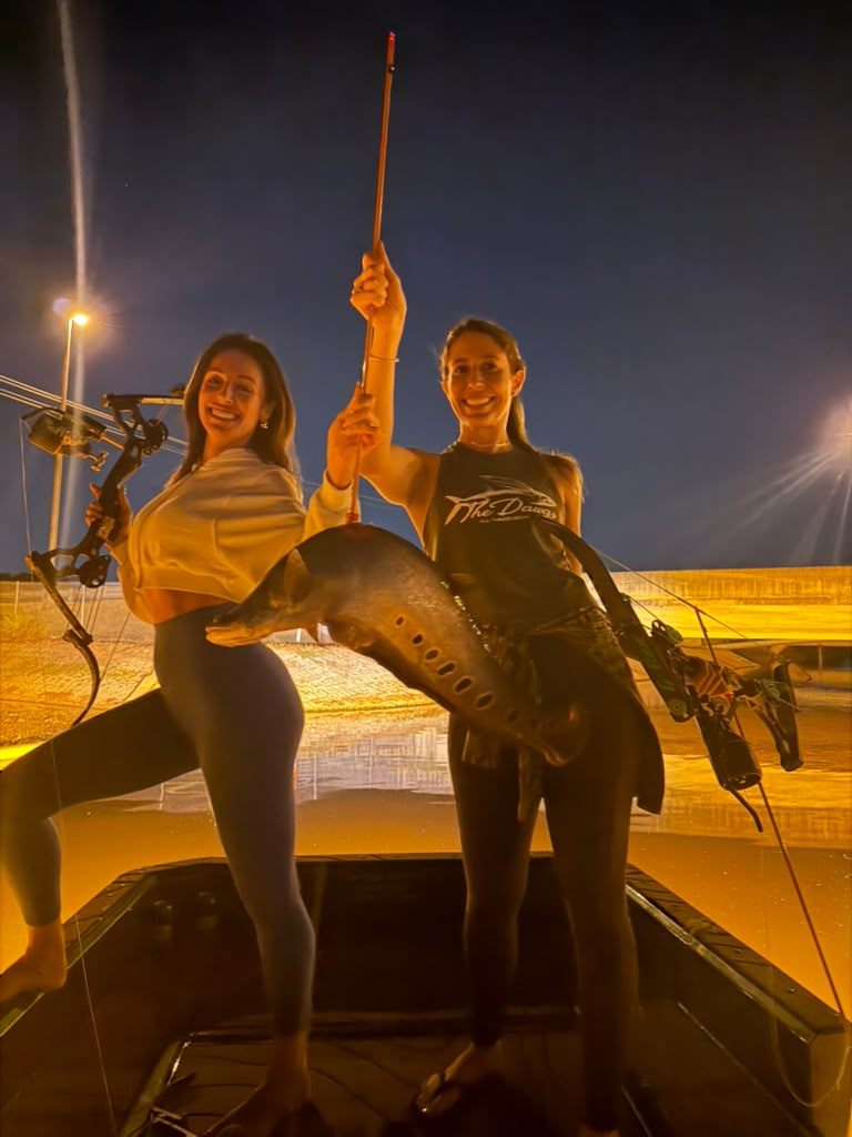 Native Roots Outdoor bowfishing trip photo with guests, fish, boat lights, and South Florida water
