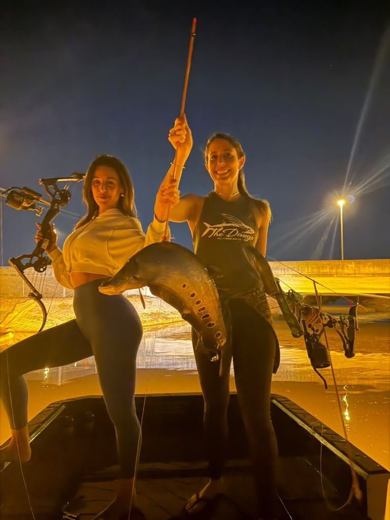 Native Roots Outdoor bowfishing trip photo with guests, fish, boat lights, and South Florida water