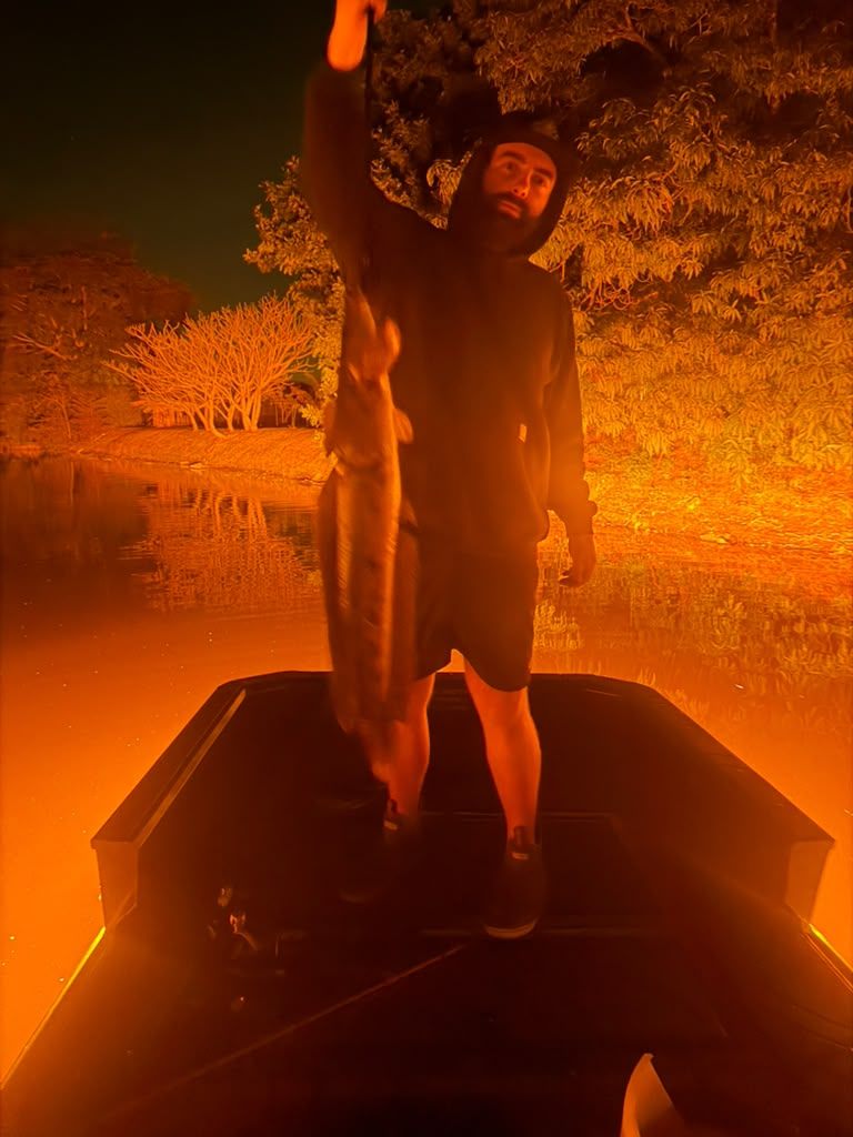Native Roots Outdoor bowfishing trip photo with guests, fish, boat lights, and South Florida water