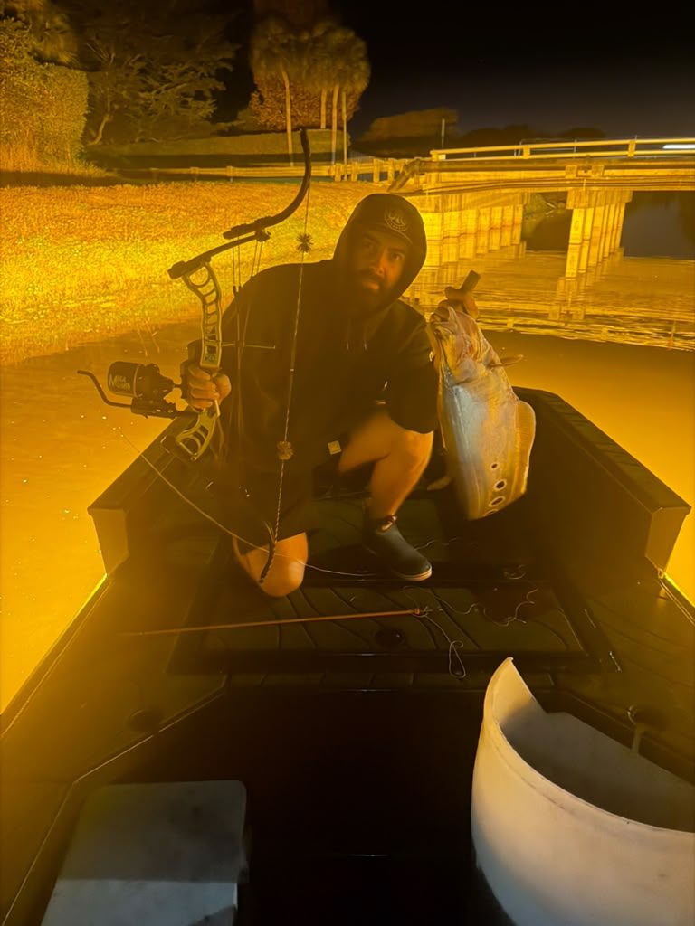 Native Roots Outdoor bowfishing trip photo with guests, fish, boat lights, and South Florida water