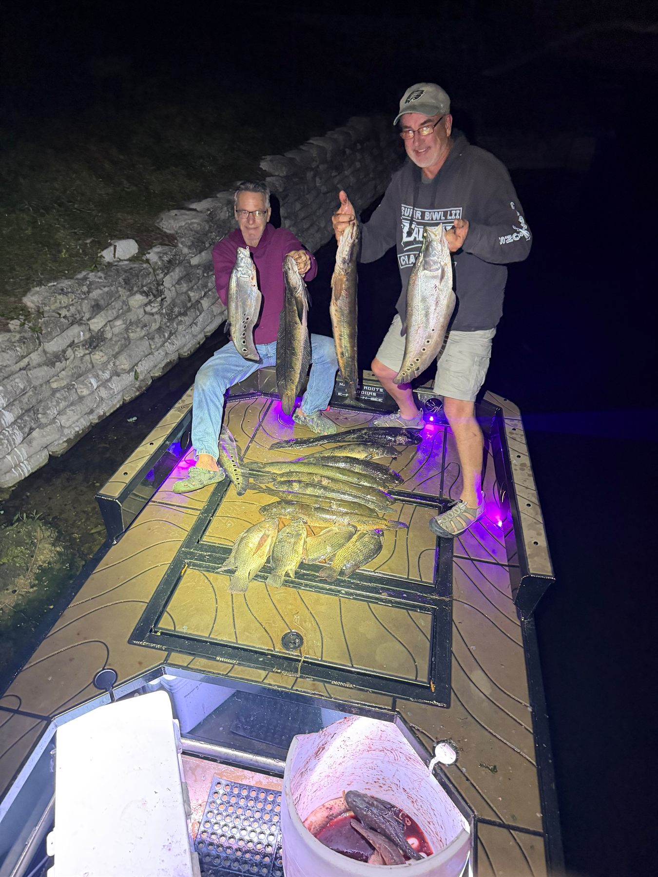 Native Roots Outdoor bowfishing trip photo with guests, fish, boat lights, and South Florida water