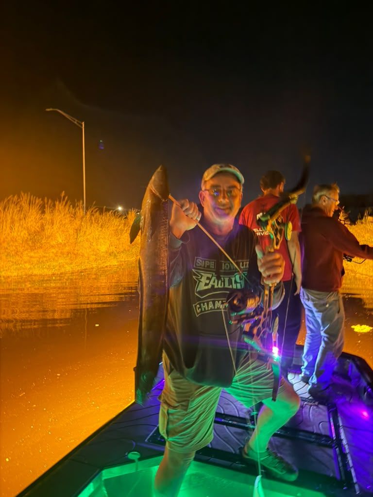 Native Roots Outdoor bowfishing trip photo with guests, fish, boat lights, and South Florida water