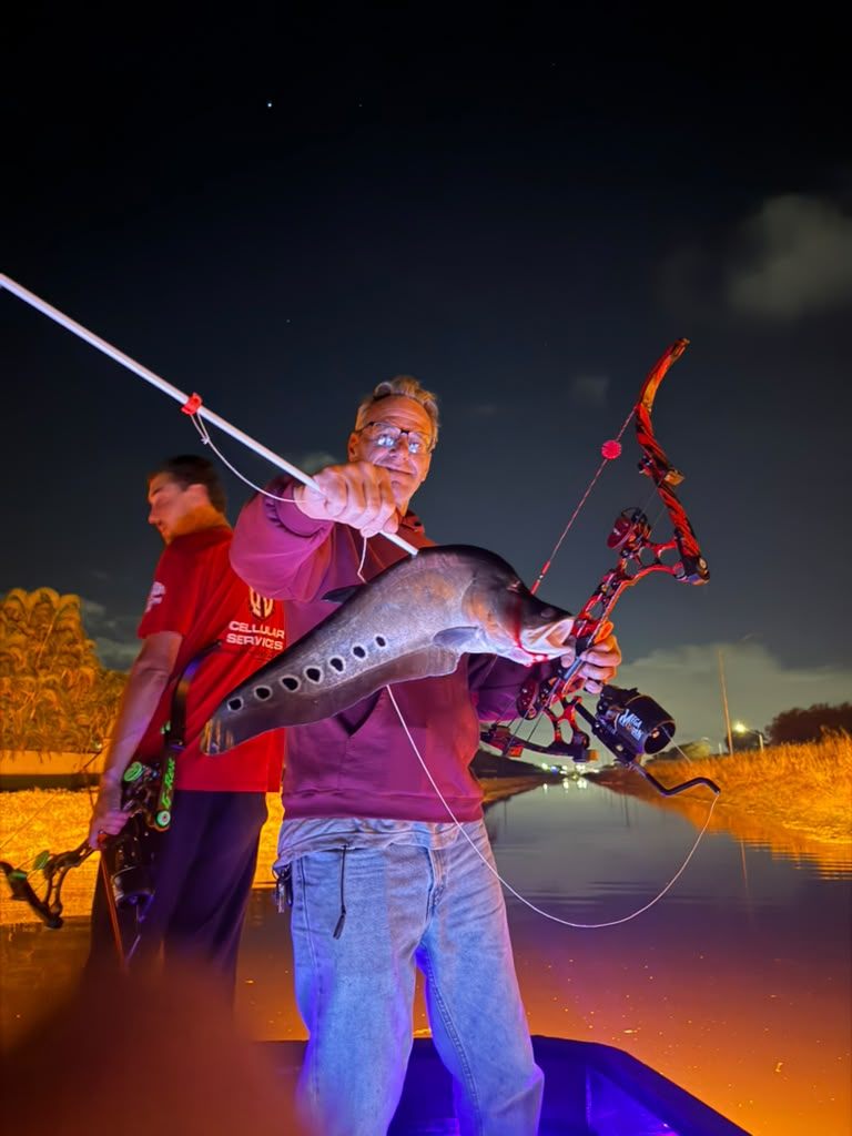 Native Roots Outdoor bowfishing trip photo with guests, fish, boat lights, and South Florida water
