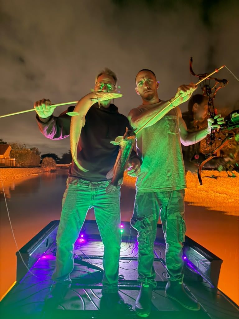 Native Roots Outdoor bowfishing trip photo with guests, fish, boat lights, and South Florida water