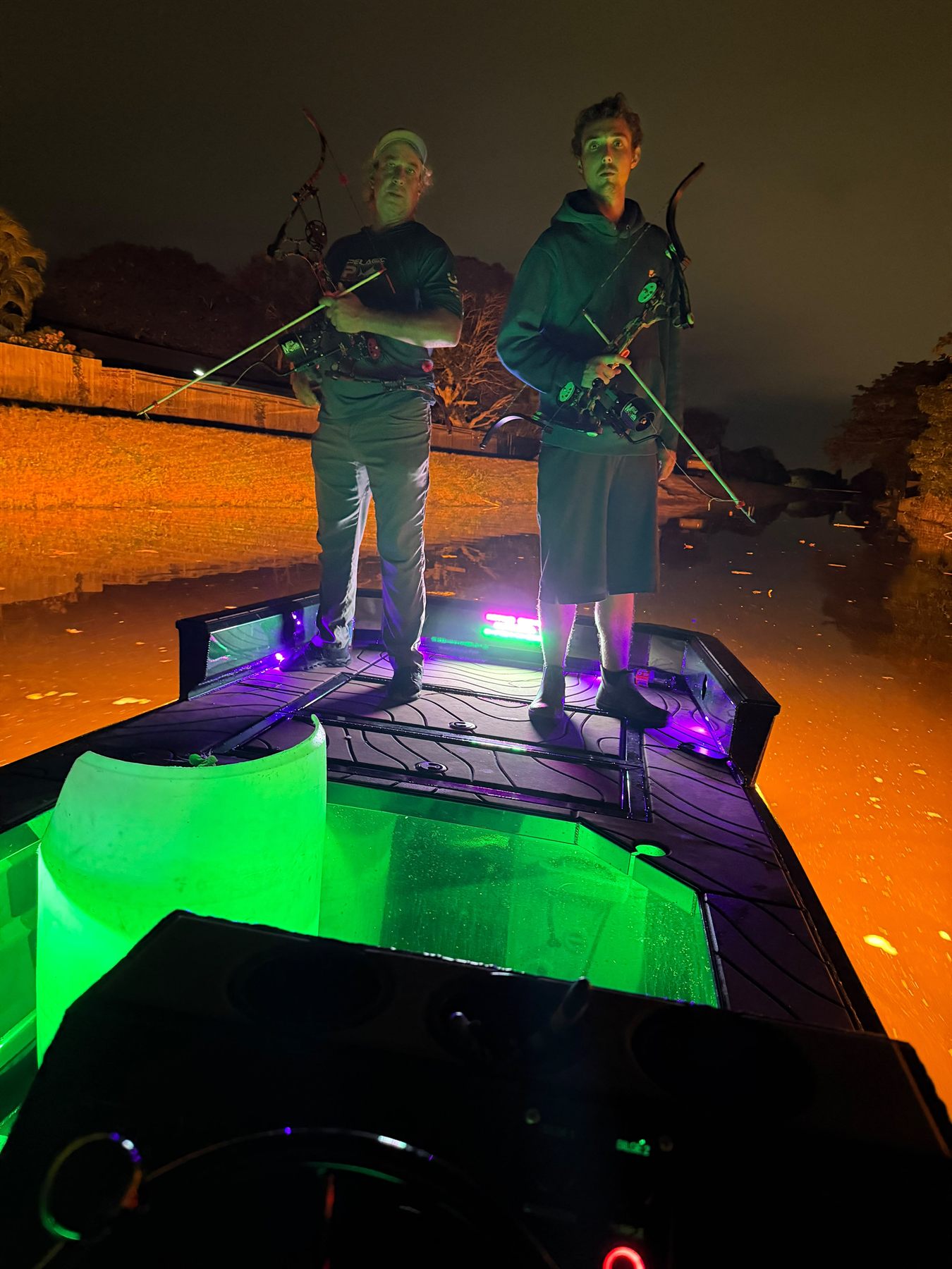 Native Roots Outdoor bowfishing trip photo with guests, fish, boat lights, and South Florida water
