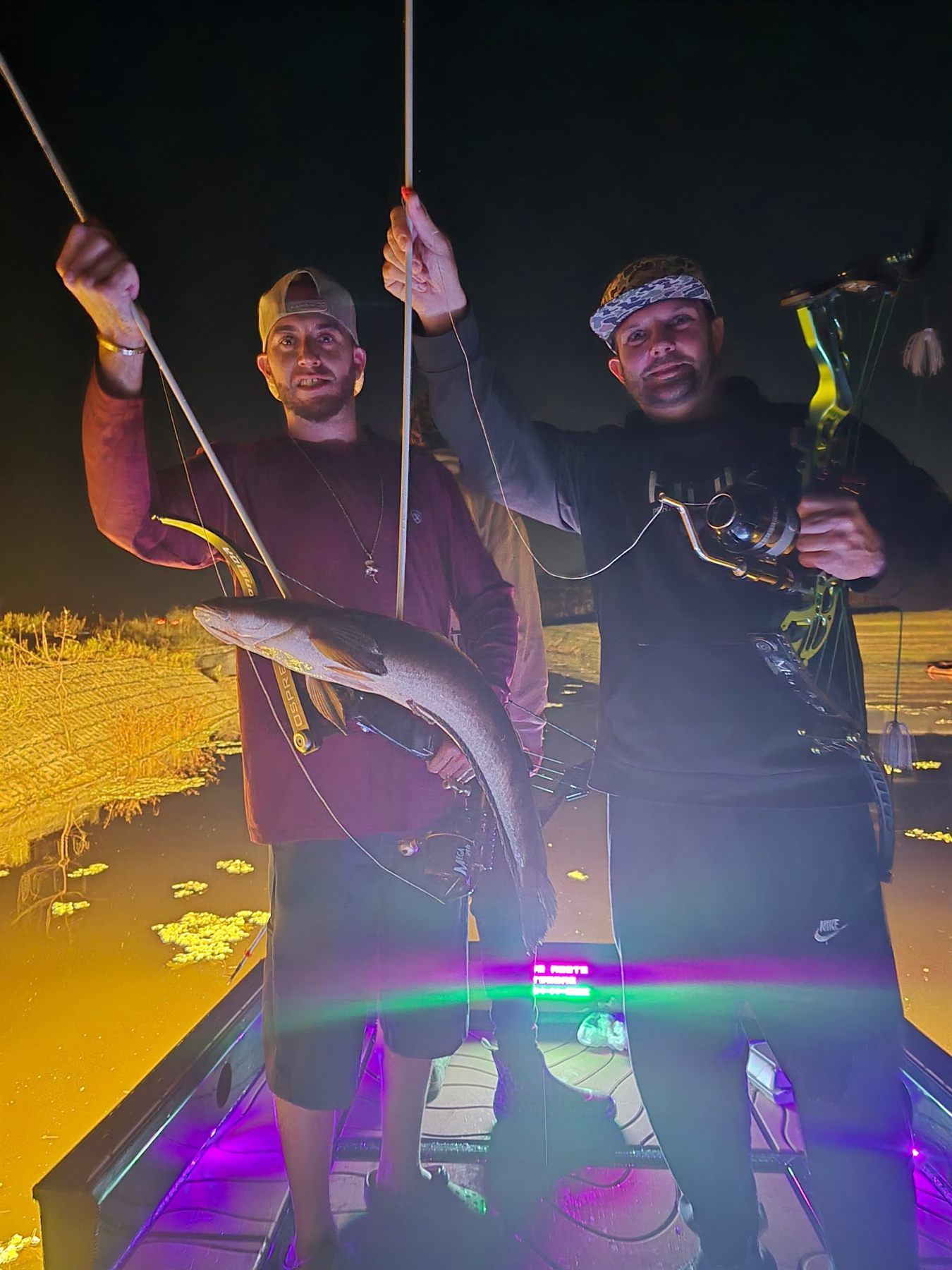 Native Roots Outdoor bowfishing trip photo with guests, fish, boat lights, and South Florida water